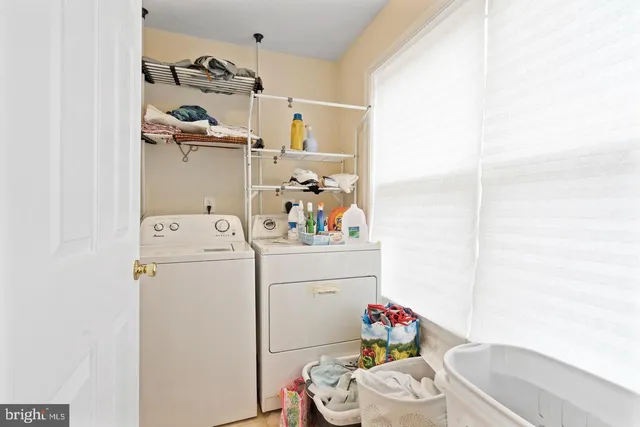 a room with a refrigerator and washer