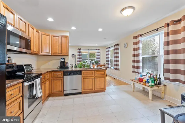 a kitchen with stainless steel appliances granite countertop a stove and cabinets
