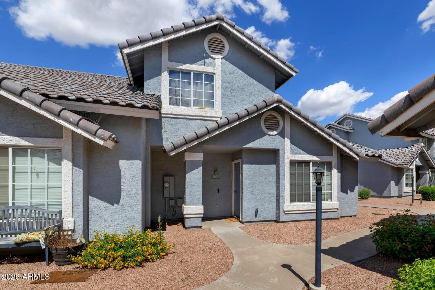 860 North McQueen Road, Unit 1121 Chandler, AZ 85225 - Photo 1 of 24 a front view of a house with a yard