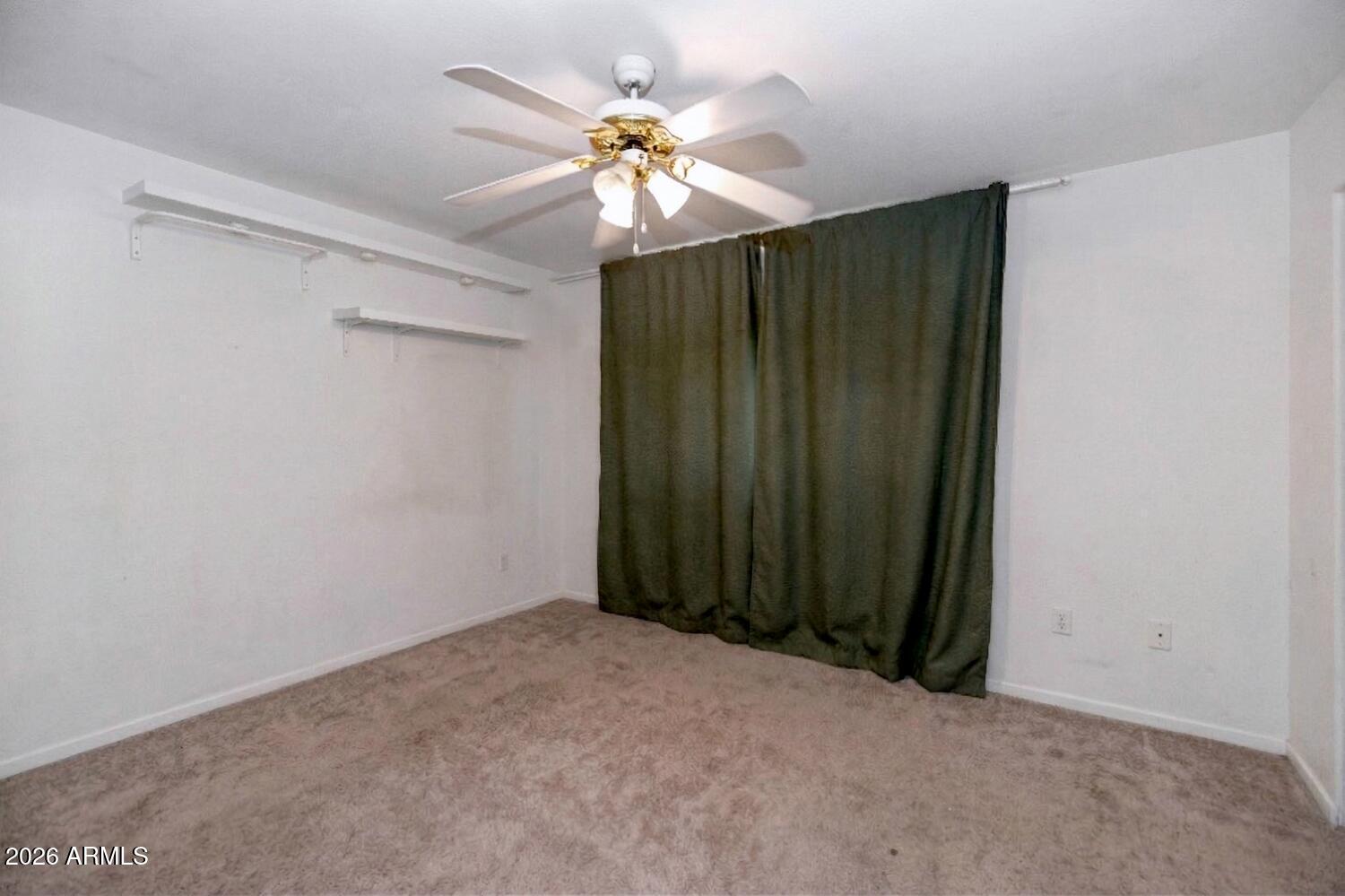 860 North McQueen Road, Unit 1121 Chandler, AZ 85225 - Photo 15 of 24 an empty room with closet and fan
