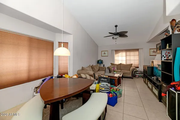 a living room with furniture a flat screen tv and a window