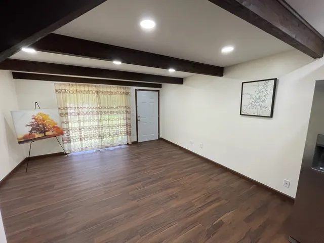 a view of a car parking space with wooden floor