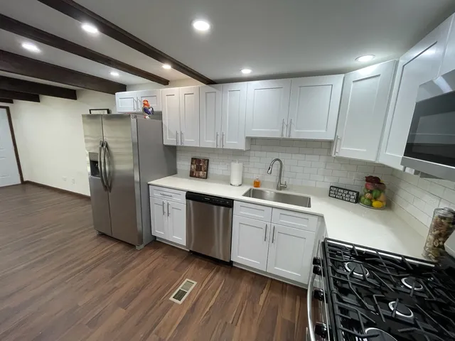 a kitchen with a sink stove and cabinets