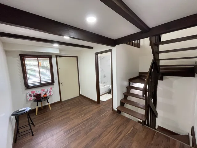 a hallway with wooden floor and furniture