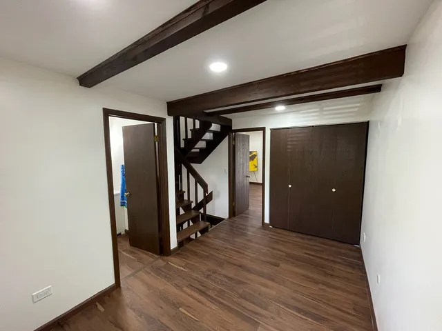 a view of hallway with wooden floor