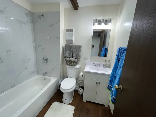 a bathroom with a sink toilet and shower