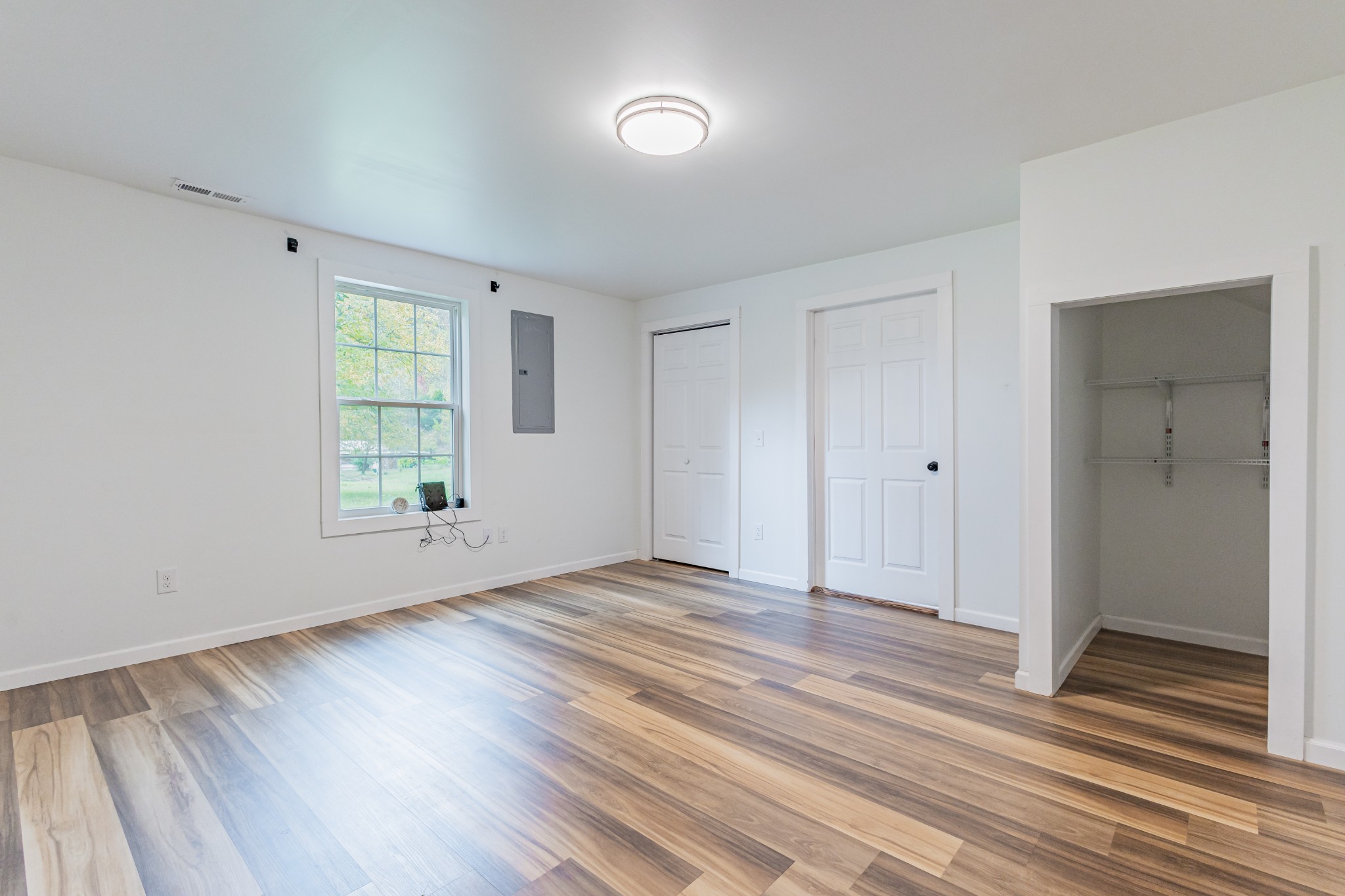 2635 McBrides Branch Road Beechgrove, TN 37018 - Photo 11 of 54 a view of an empty room with wooden floor and a window
