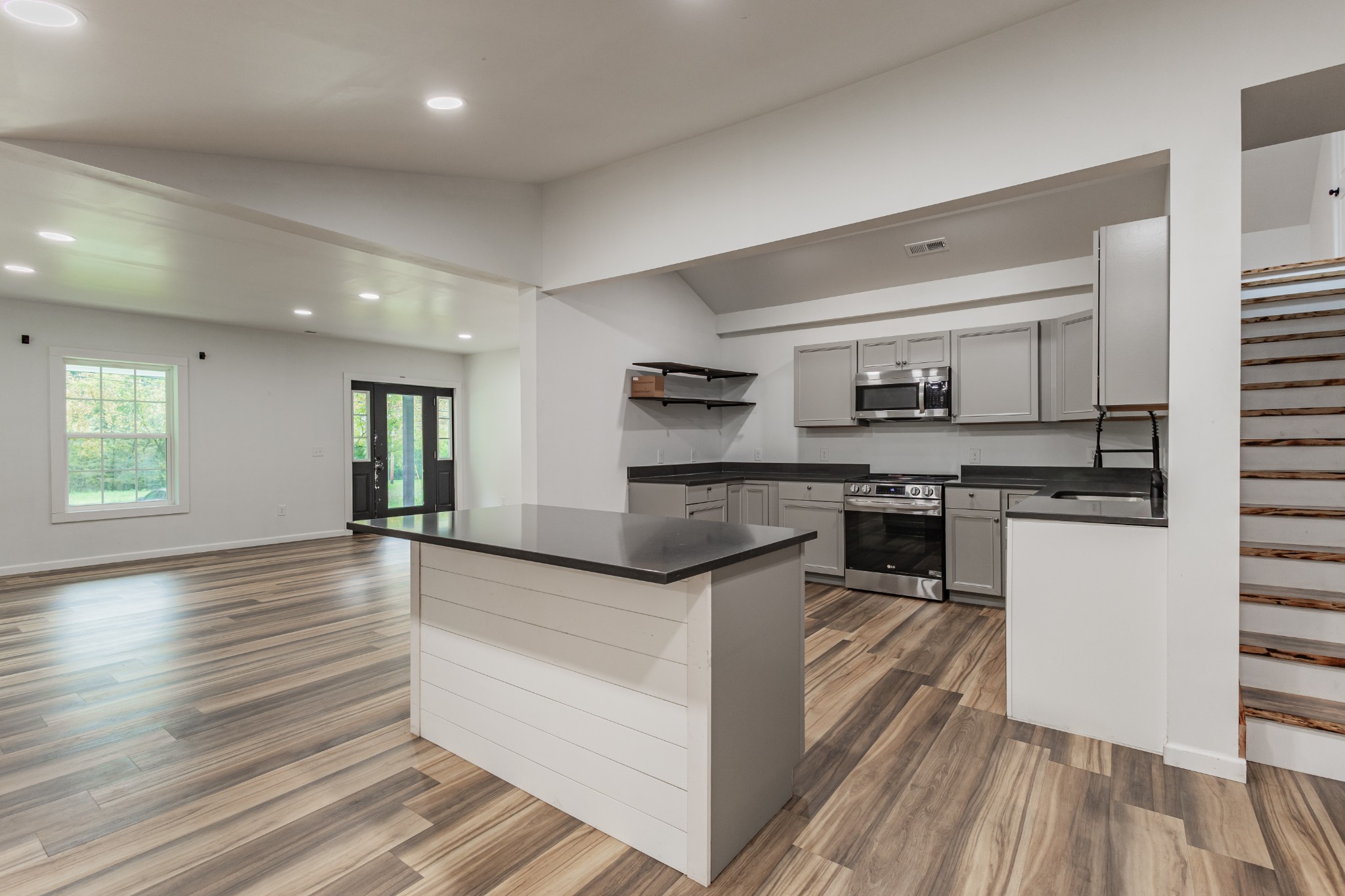 2635 McBrides Branch Road Beechgrove, TN 37018 - Photo 19 of 54 a kitchen with stainless steel appliances granite countertop a stove and a sink