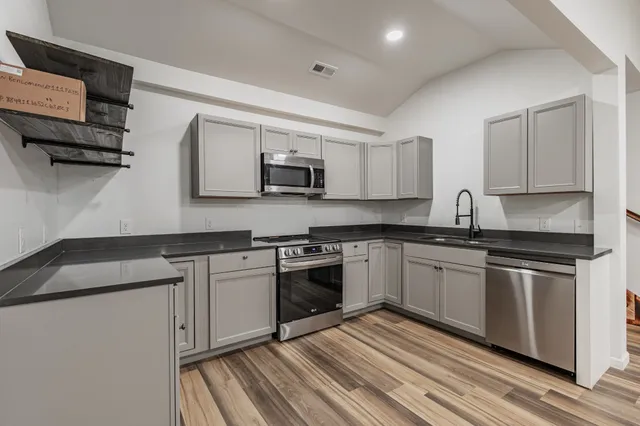 a view of a room with wooden floor and natural light