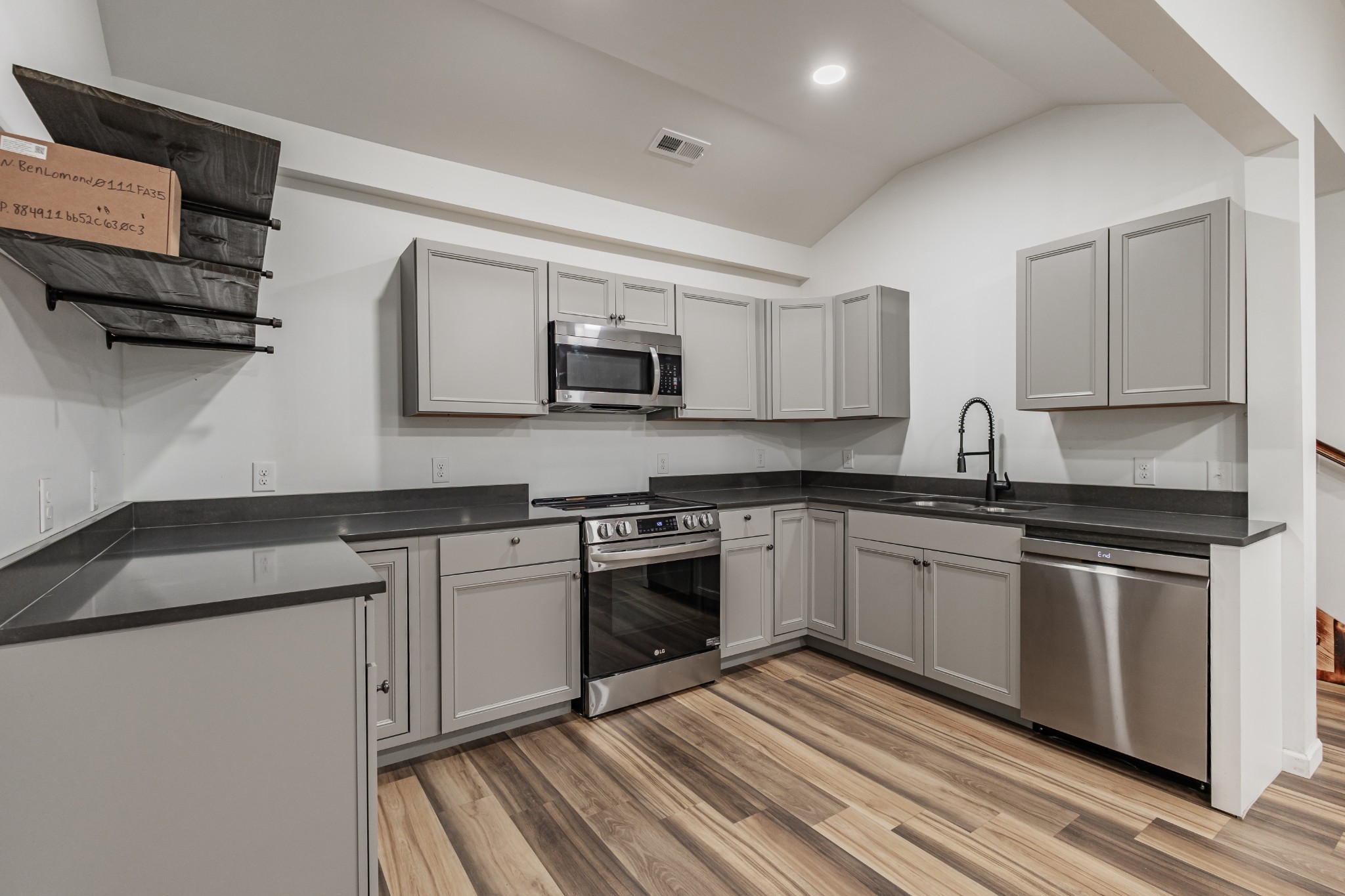 2635 McBrides Branch Road Beechgrove, TN 37018 - Photo 23 of 54 a kitchen with stainless steel appliances granite countertop a stove a sink and a microwave