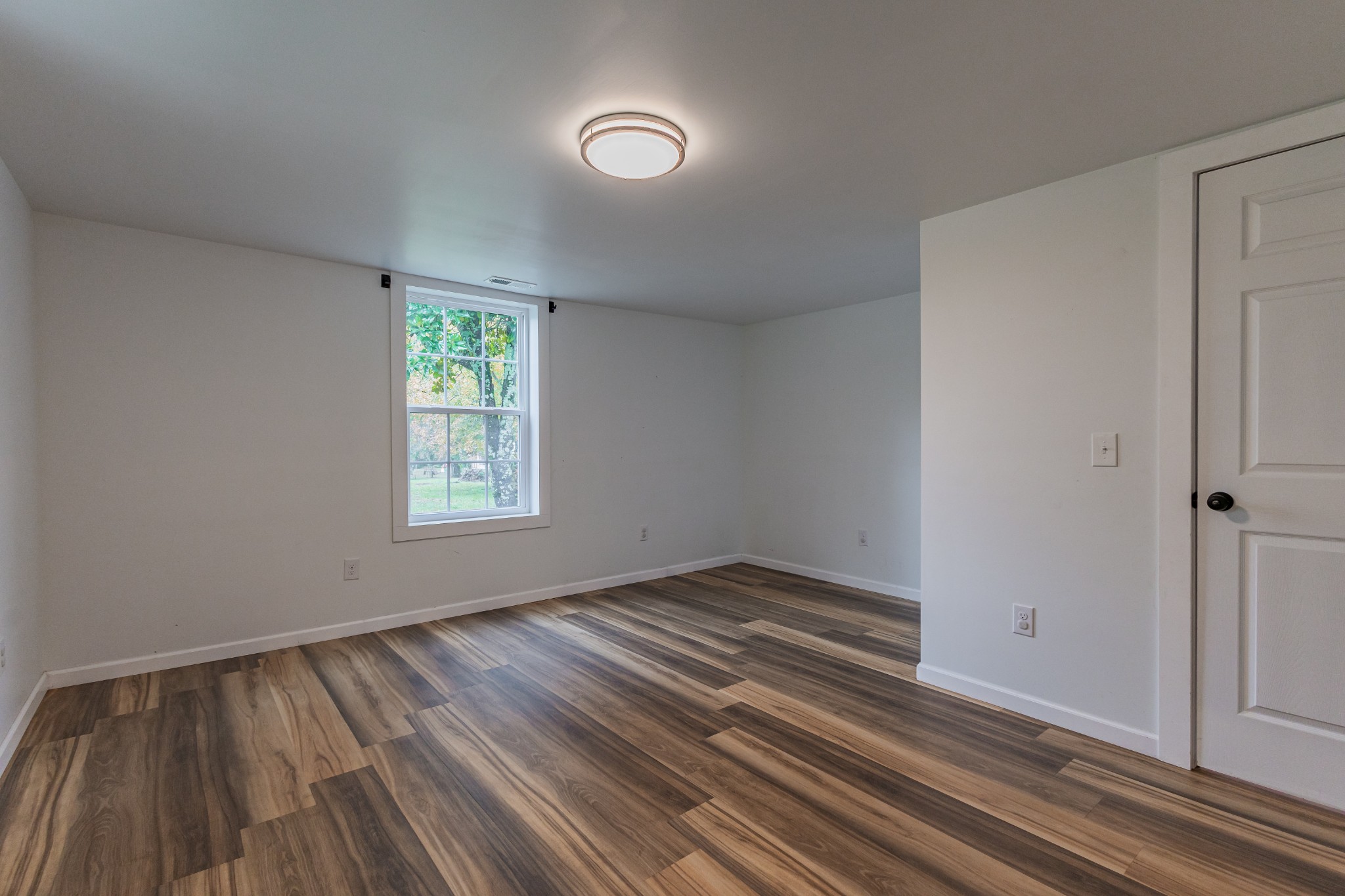 2635 McBrides Branch Road Beechgrove, TN 37018 - Photo 8 of 54 a view of an empty room with wooden floor and a window