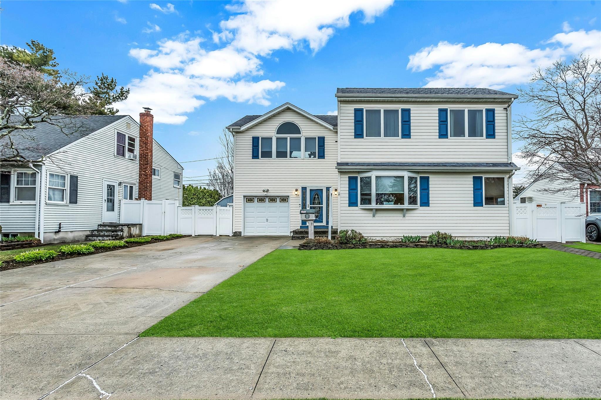 12 Ceil Place Bethpage, NY 11714 - Photo 1 of 1 a front view of a house with a garden