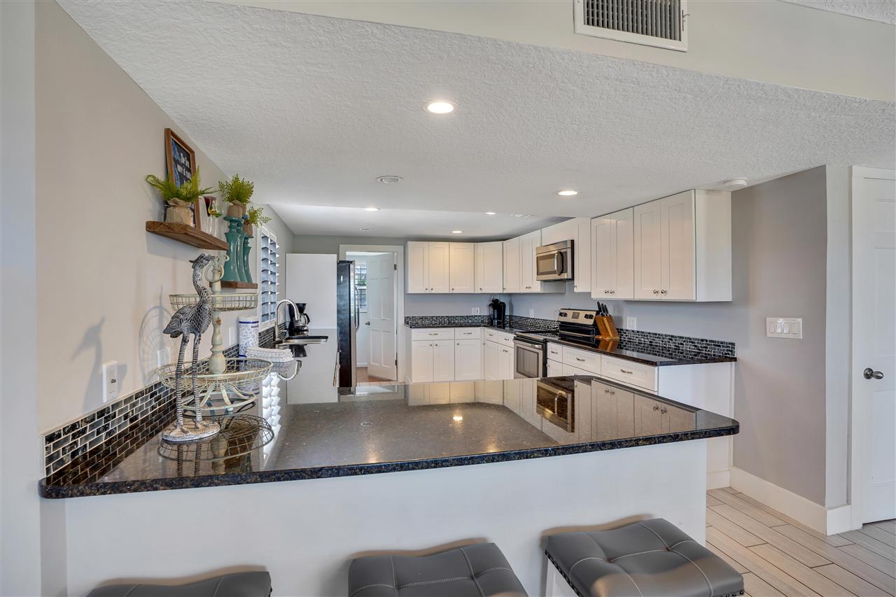 5072 Atlantic View St. Augustine, FL 32080 - Photo 14 of 40 a kitchen with stainless steel appliances granite countertop a sink a stove and refrigerator