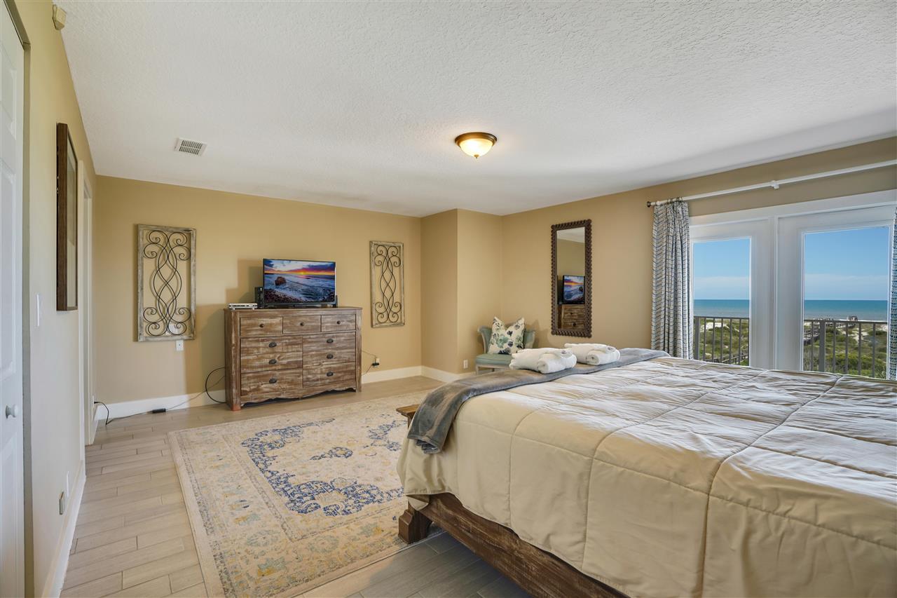 5072 Atlantic View St. Augustine, FL 32080 - Photo 17 of 40 a spacious bedroom with a bed and a dresser