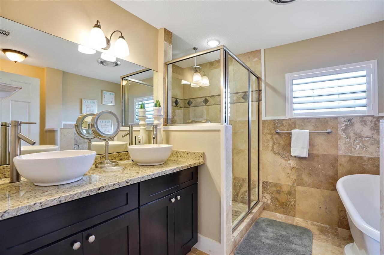 5072 Atlantic View St. Augustine, FL 32080 - Photo 21 of 40 a bathroom with a granite countertop sink and a mirror