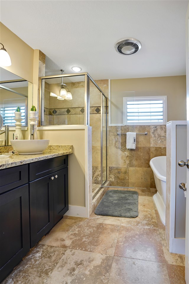 5072 Atlantic View St. Augustine, FL 32080 - Photo 22 of 40 a bathroom with a granite countertop sink a toilet and a shower