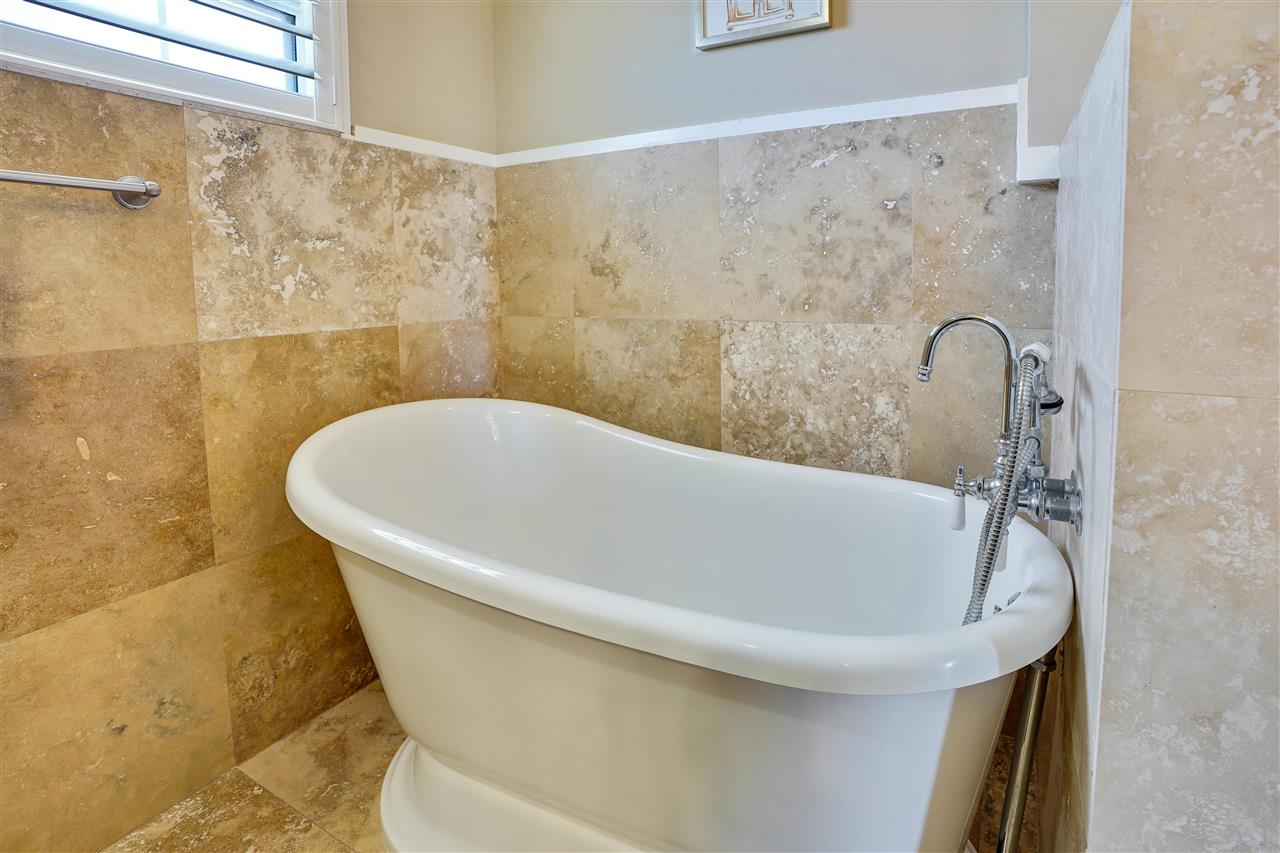 5072 Atlantic View St. Augustine, FL 32080 - Photo 24 of 40 a white bath tub sitting in a bathroom