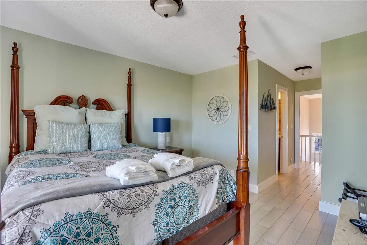 5072 Atlantic View St. Augustine, FL 32080 - Photo 26 of 40 a bedroom with a bed and a table in it