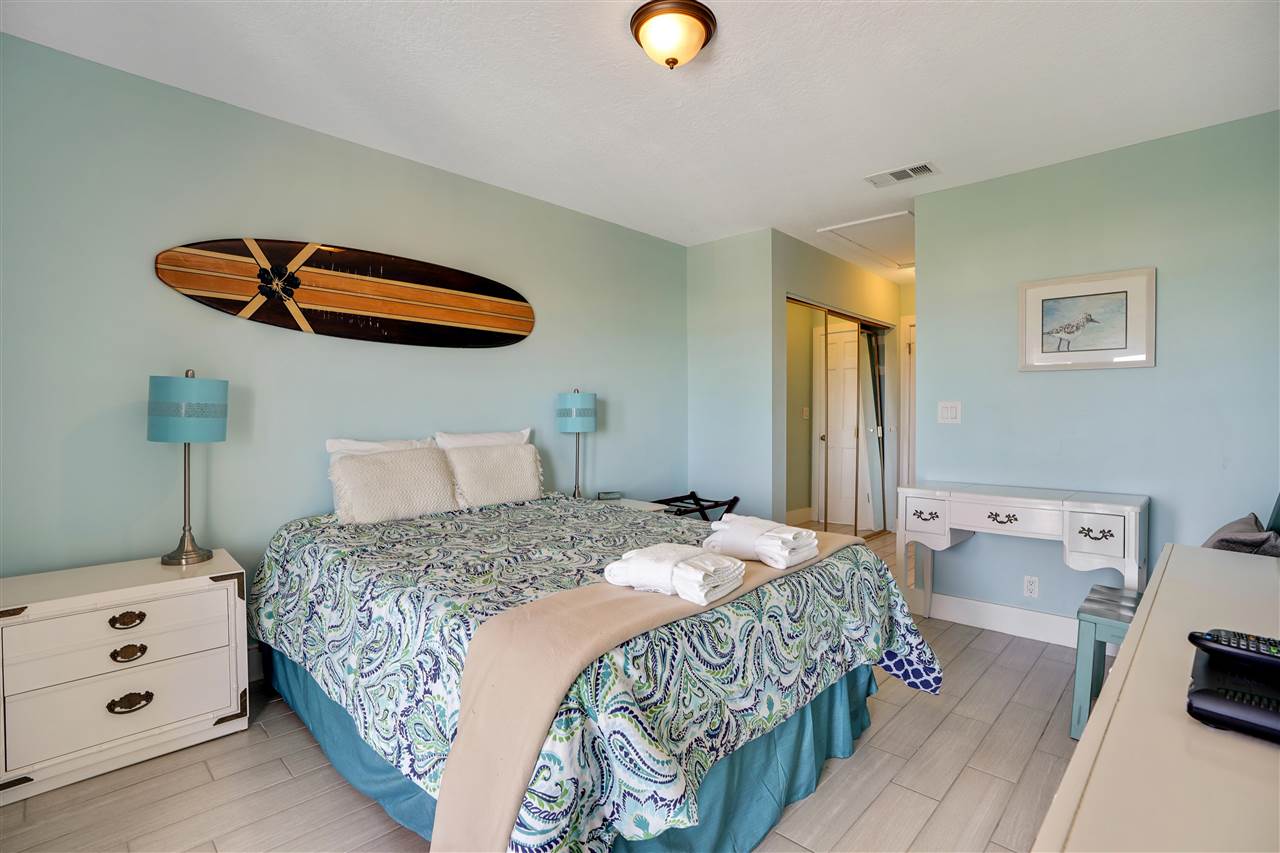 5072 Atlantic View St. Augustine, FL 32080 - Photo 29 of 40 a bedroom with a bed and a lamp on dresser