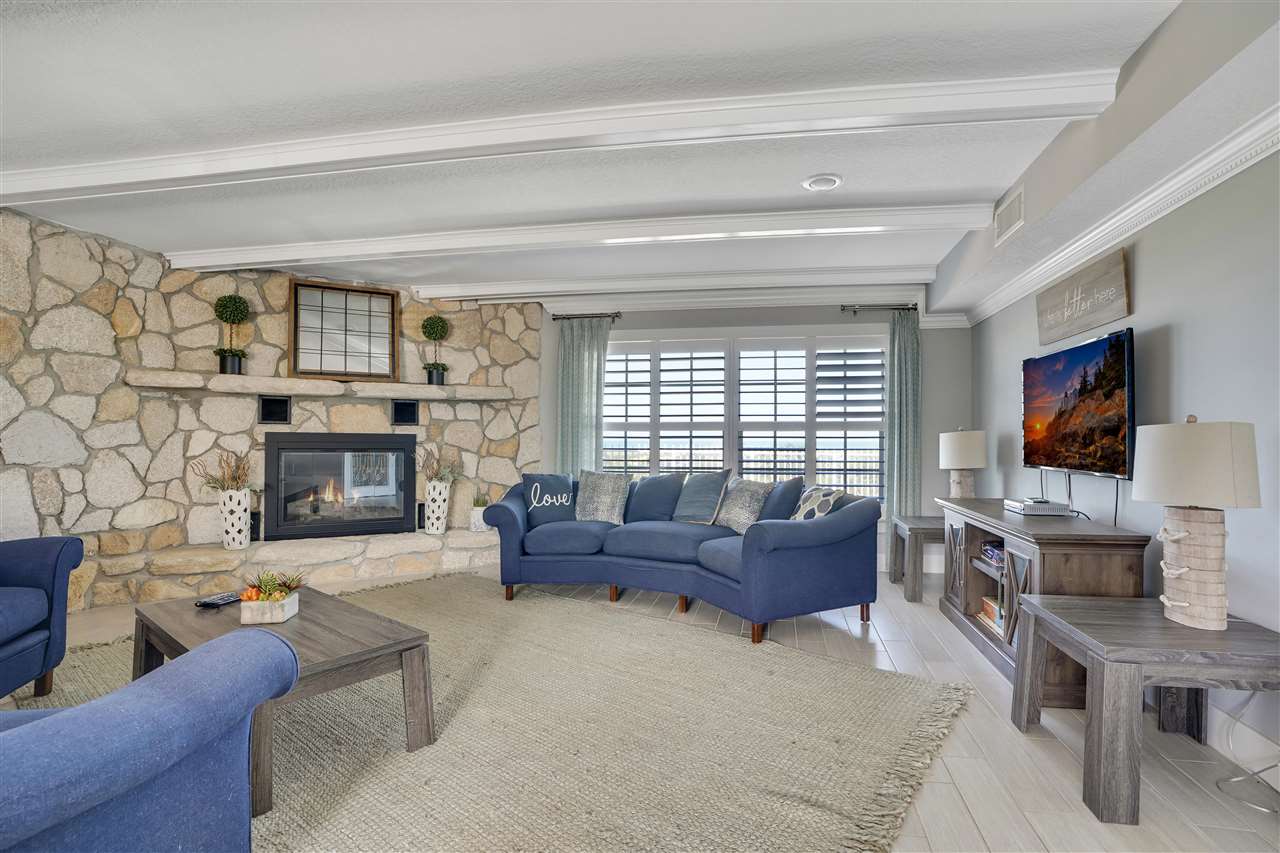 5072 Atlantic View St. Augustine, FL 32080 - Photo 9 of 40 a living room with furniture a fireplace and a flat screen tv