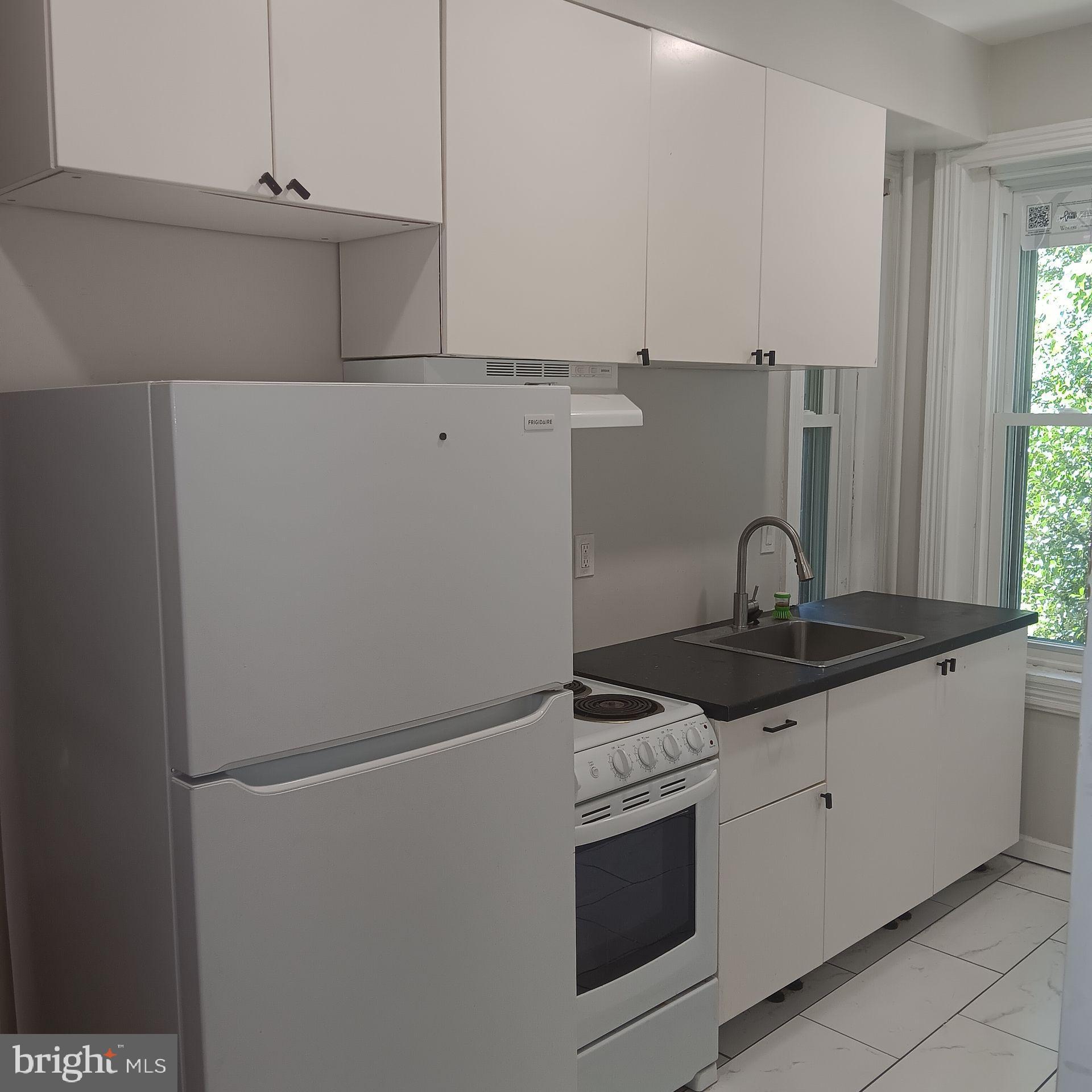 a kitchen with stainless steel appliances granite countertop a sink and a stove