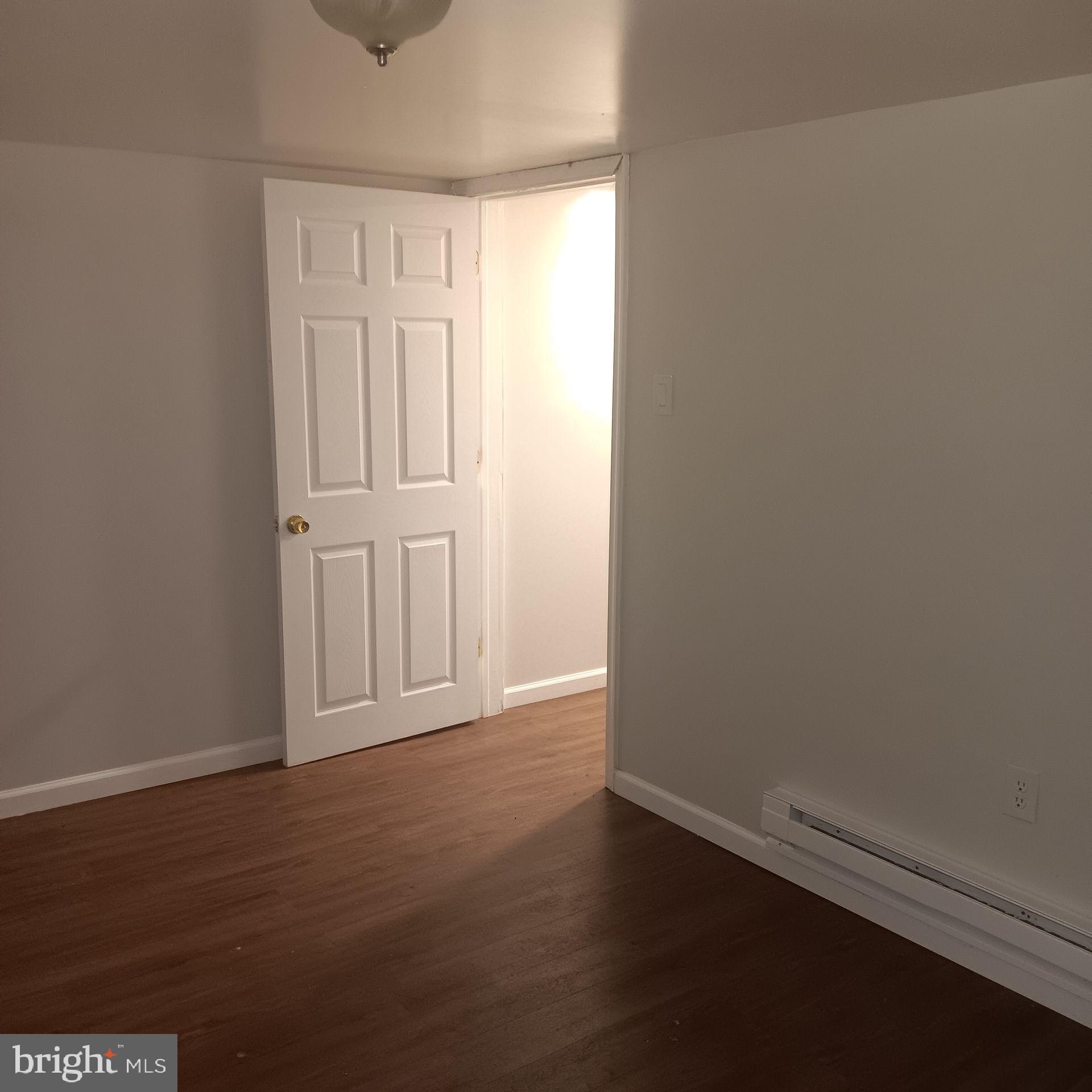 1342 Orthodox Street, Unit 2 Philadelphia, PA 19124 - Photo 4 of 6 an empty room with wooden floor