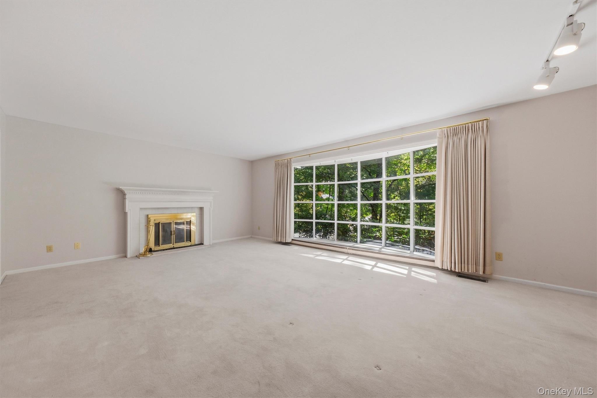 75 Pleasant Ridge Drive Poughkeepsie, NY 12603 - Photo 7 of 47 Expansive formal living room with large bow window and wood burning fireplace. Hardwood under carpet.