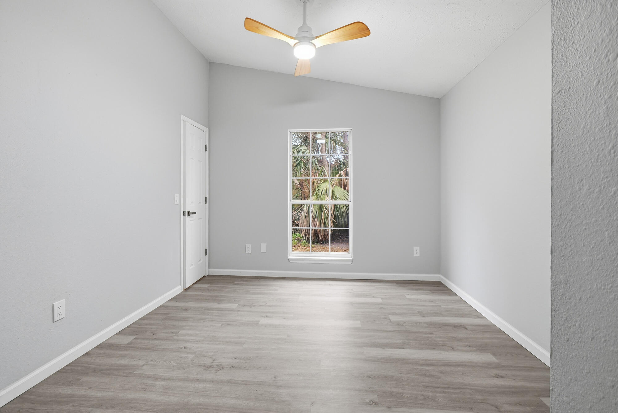 1434 Santa Anita Drive Lynn Haven, FL 32444 - Photo 23 of 38 a view of an empty room with wooden floor and a window