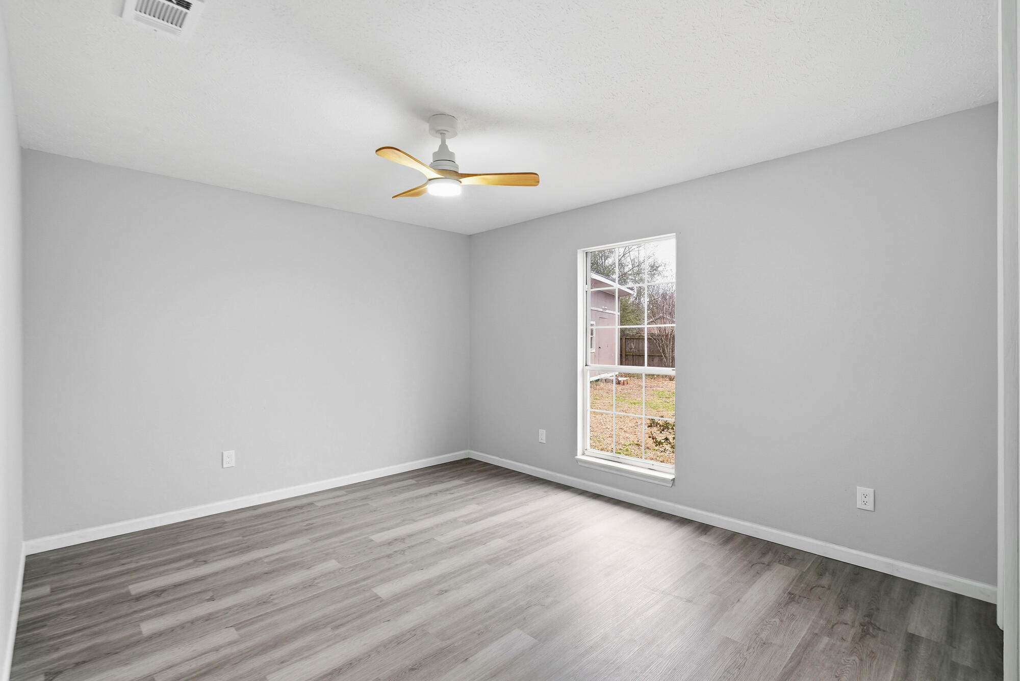 1434 Santa Anita Drive Lynn Haven, FL 32444 - Photo 27 of 38 wooden floor in an empty room with a window