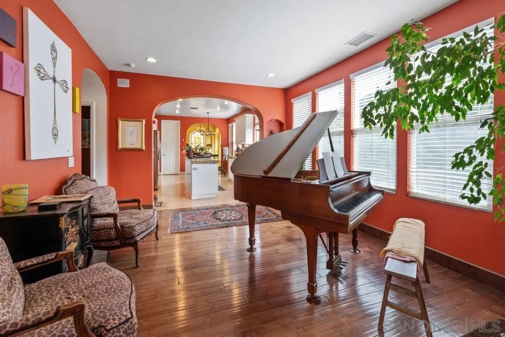 2775 Ridgegate Row La Jolla, CA 92037 - Photo 23 of 59 a living room with furniture a rug and a potted plant