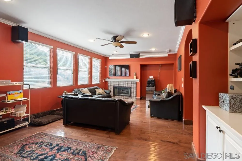 2775 Ridgegate Row La Jolla, CA 92037 - Photo 24 of 59 a living room with furniture fireplace and a large window