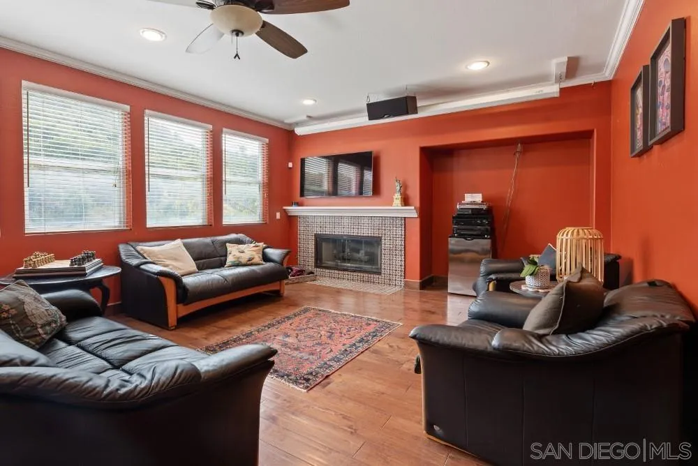 2775 Ridgegate Row La Jolla, CA 92037 - Photo 25 of 59 a living room with furniture and a fireplace