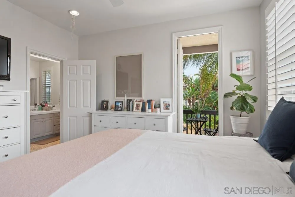 2775 Ridgegate Row La Jolla, CA 92037 - Photo 47 of 59 a bedroom with a bed and a potted plant