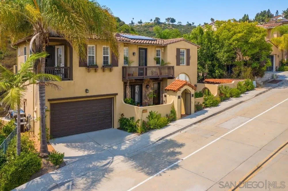 2775 Ridgegate Row La Jolla, CA 92037 - Photo 49 of 59 a front view of a house with a yard and potted plants