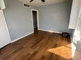 an empty room with wooden floor