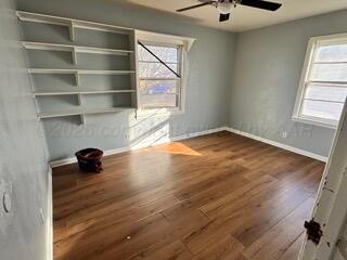 4118 South Harrison Street Amarillo, TX 79110 - Photo 8 of 19 an empty room with wooden floor and windows