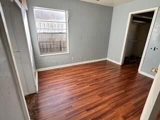 4118 South Harrison Street Amarillo, TX 79110 - Photo 9 of 19 a view of an empty room with wooden floor and a window