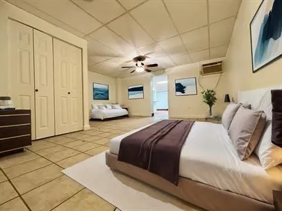 a spacious bedroom with a bed and a chandelier