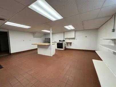 a view of kitchen and refrigerator