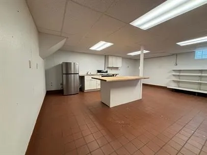 a kitchen with stainless steel appliances a refrigerator and a stove top oven