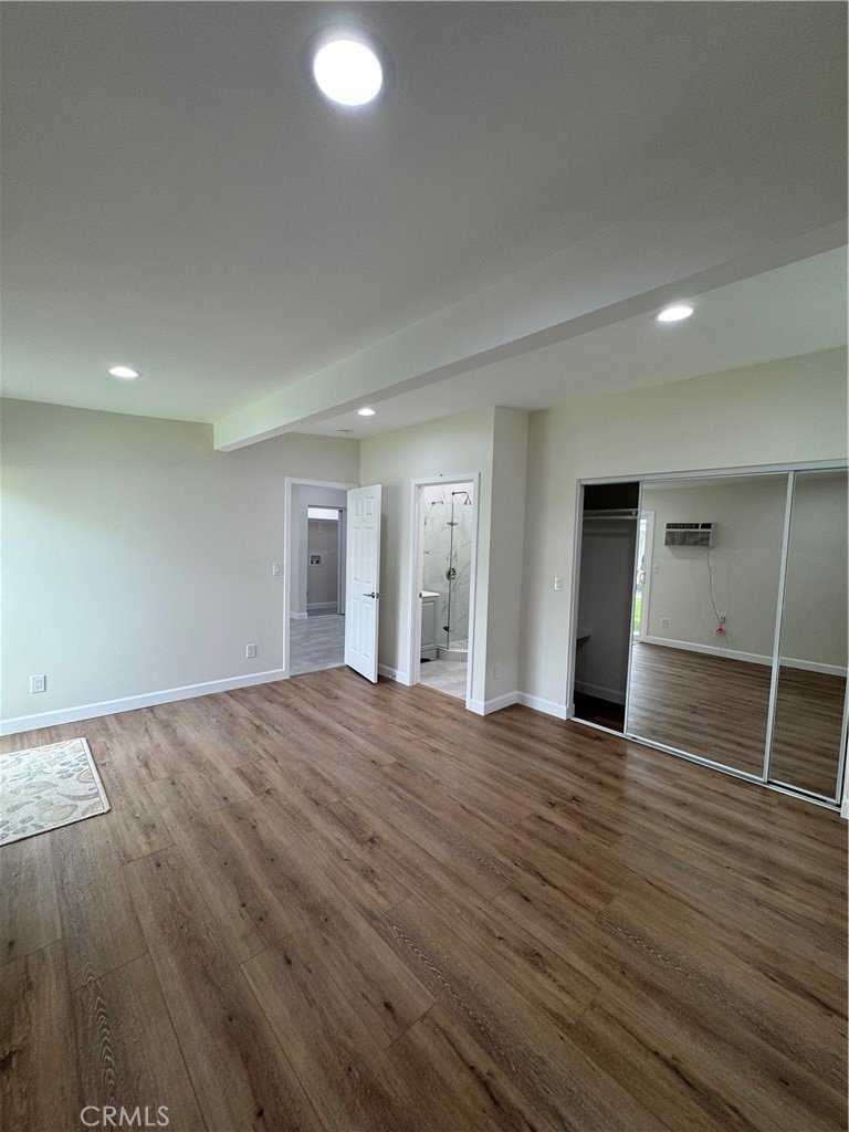 8418 Stewart And Gray Road Downey, CA 90241 - Photo 11 of 17 an empty room with wooden floor and bathroom