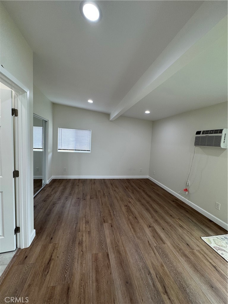 8418 Stewart And Gray Road Downey, CA 90241 - Photo 12 of 17 an empty room with wooden floor and windows