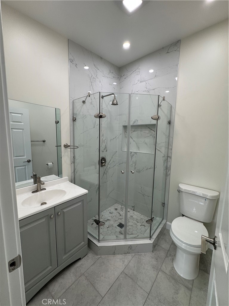 8418 Stewart And Gray Road Downey, CA 90241 - Photo 14 of 17 a spacious bathroom with a shower sink mirror and toilet