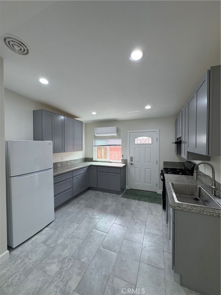 8418 Stewart And Gray Road Downey, CA 90241 - Photo 5 of 17 a kitchen with refrigerator and cabinets