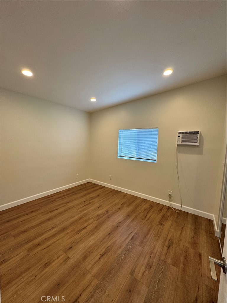 8418 Stewart And Gray Road Downey, CA 90241 - Photo 7 of 17 an empty room with wooden floor and windows