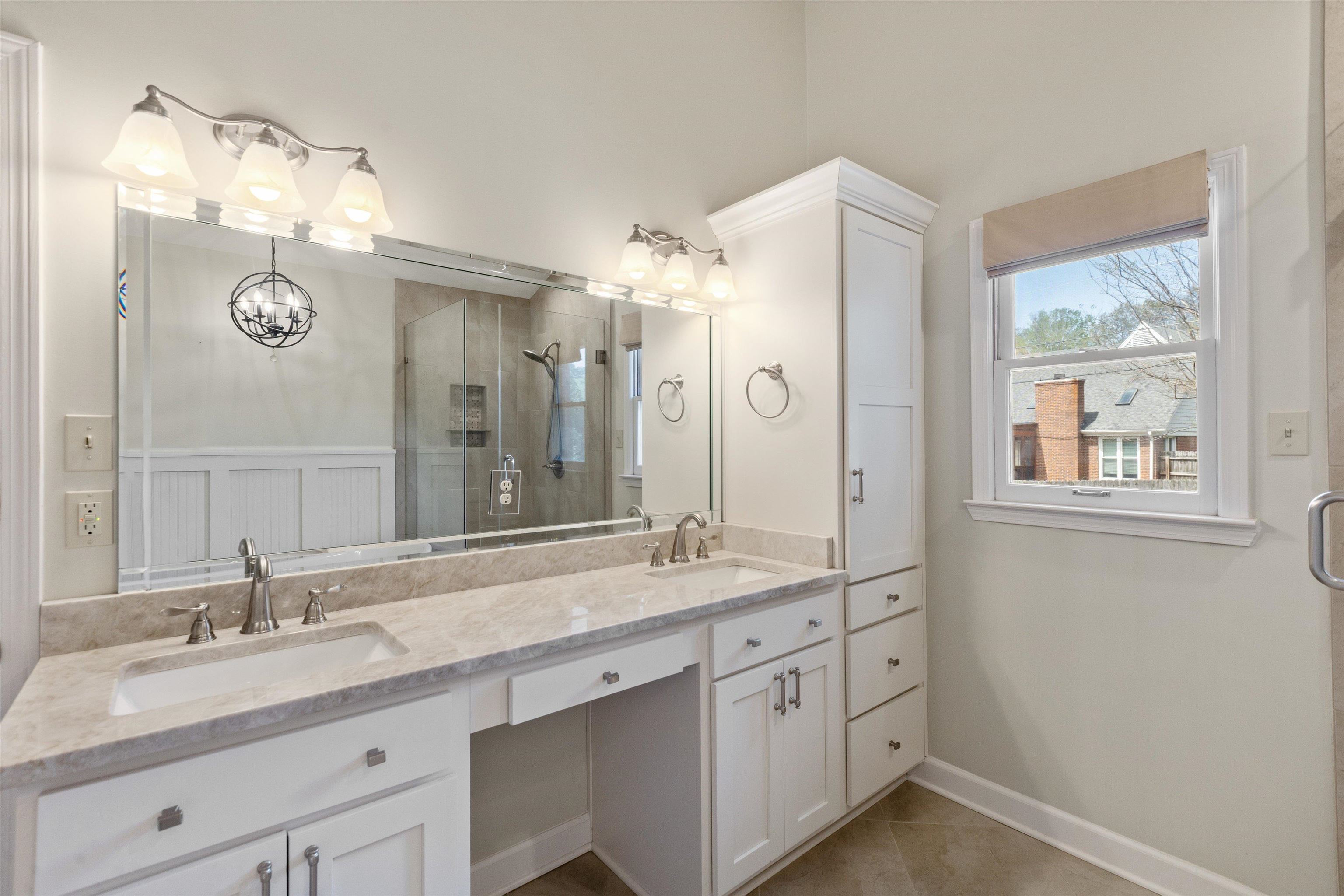 7792 Fawn Ridge Cove Memphis, TN 38016 - Photo 15 of 26 Bathroom featuring double vanity, a sink, a stall shower, and tile patterned floors