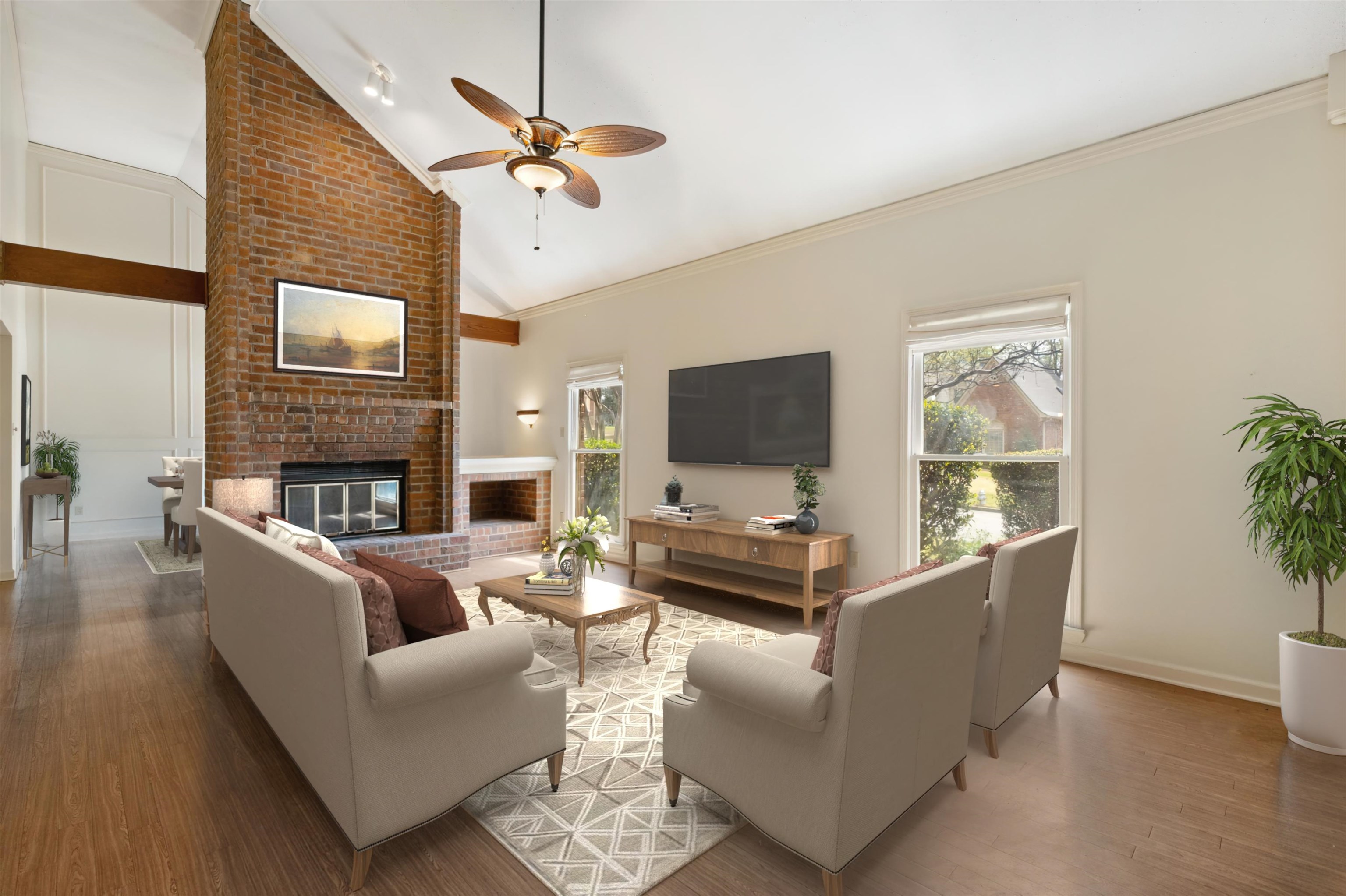 7792 Fawn Ridge Cove Memphis, TN 38016 - Photo 4 of 26 Living area featuring ornamental molding, a wealth of natural light, a ceiling fan, and wood finished floors