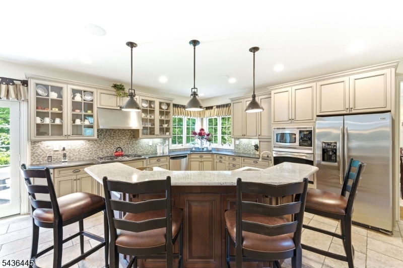 4 Windemere Way Sparta, NJ 07871 - Photo 12 of 50 a dining area with furniture a chandelier and kitchen view