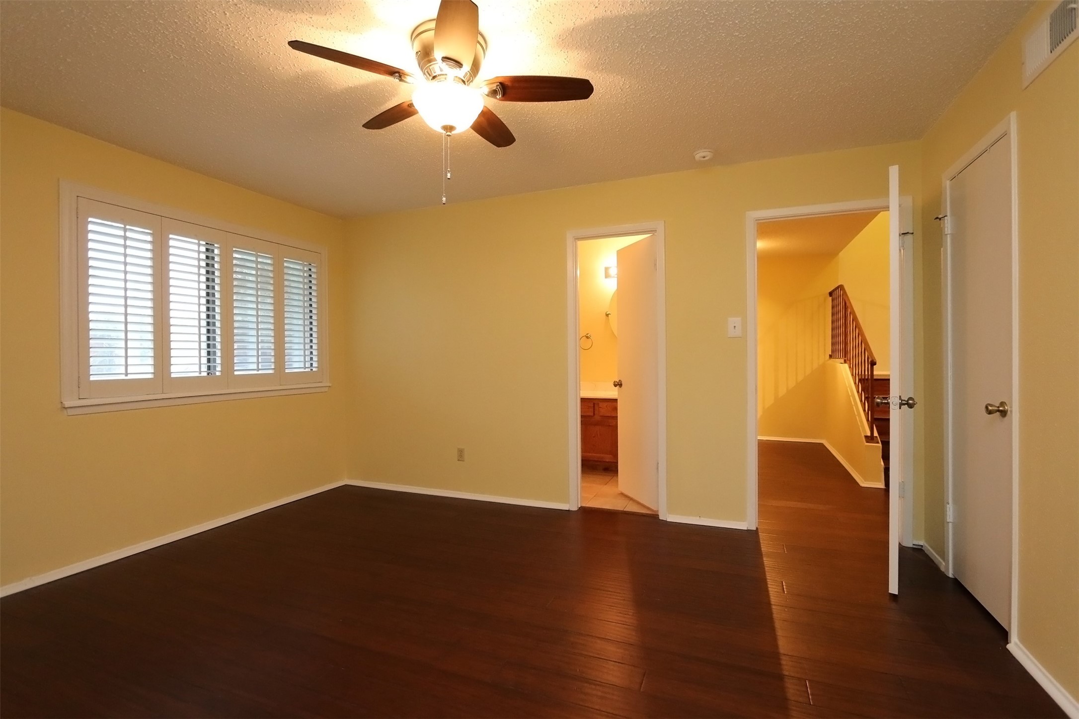 6430 Kentwick Drive Houston, TX 77084 - Photo 4 of 26 a view of an empty room with wooden floor and a window