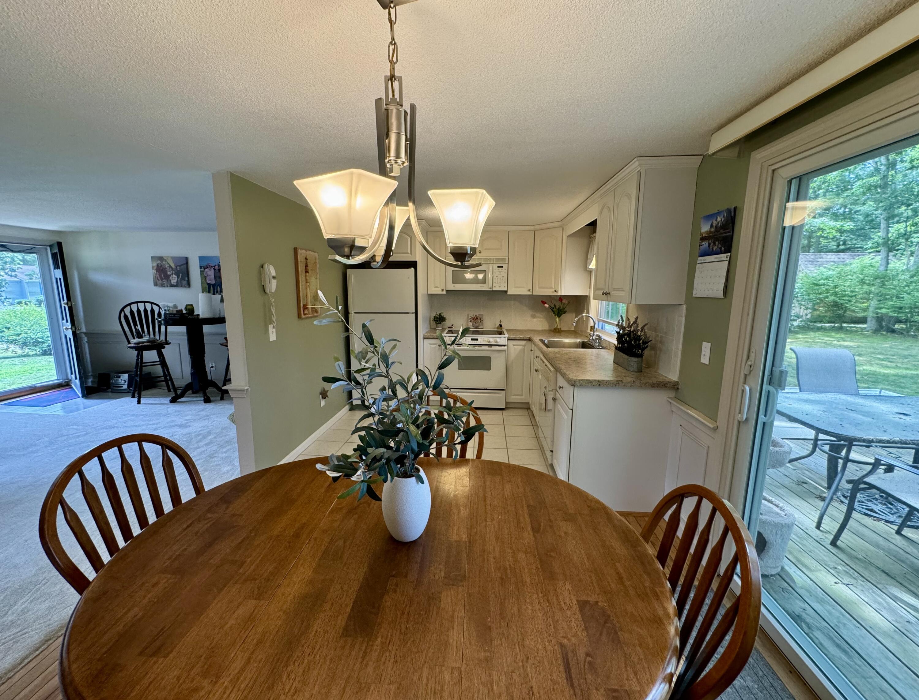 173 Nottingham Drive Centerville, MA 02632 - Photo 12 of 54 a view of a dining room with furniture window and outside view